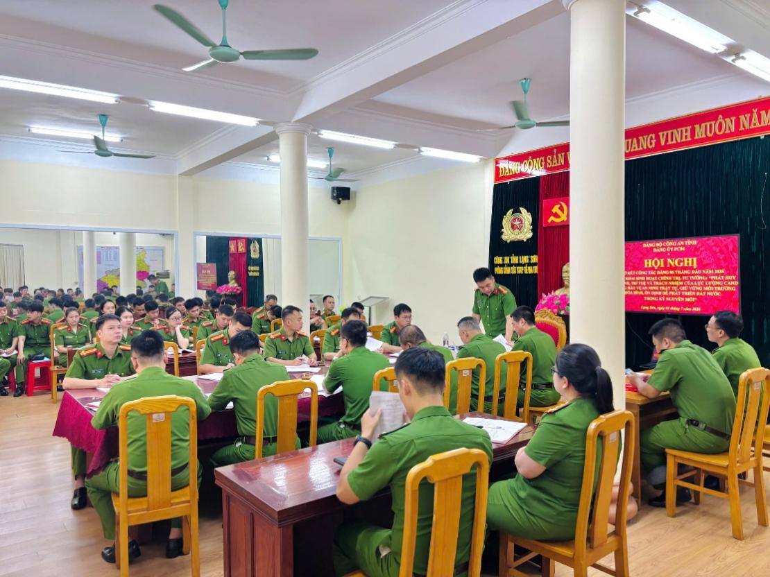 The image shows a room filled with people, likely in a meeting or ceremony, with decorations and banners, and some written Vietnamese phrases on a document.

AI-generated content may be incorrect.